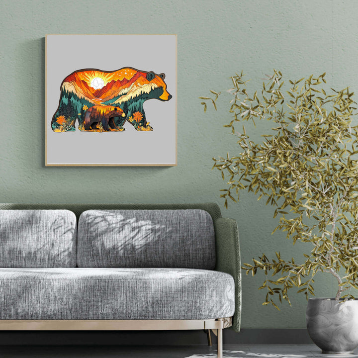 Bears in the forest artwork displayed above a grey sofa in a modern living room with plants.