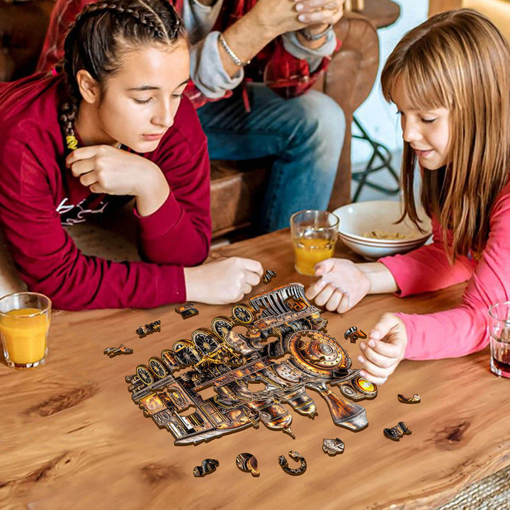 Two girls assembling a 3D Mechanical Steam Train Wooden Jigsaw Puzzle on a table surrounded by drinks.