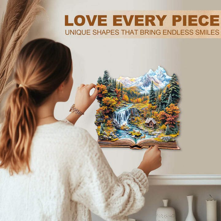 A woman placing a unique-shaped Autumn Wonderland jigsaw puzzle on a wall, showcasing vibrant fall scenery.