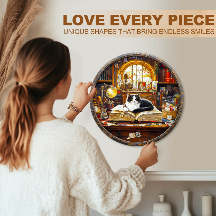 Woman enjoying the Whiskers Library-2 wooden jigsaw puzzle featuring a cat on a book in a cozy library setting.