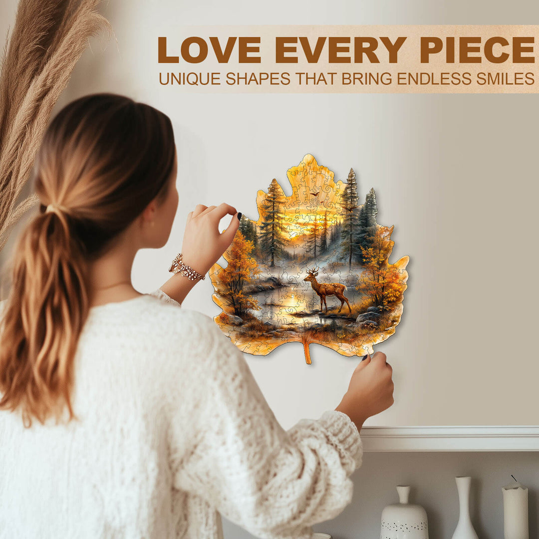 Person assembling a unique leaf-shaped jigsaw puzzle featuring a deer and forest scene, promoting joy and focus.